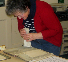 person inspecting an exhibit on a table